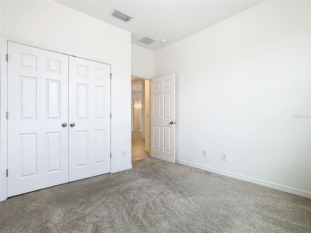 unfurnished bedroom with carpet floors and a closet