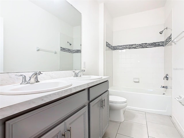 full bathroom featuring vanity, tiled shower / bath, tile patterned floors, and toilet