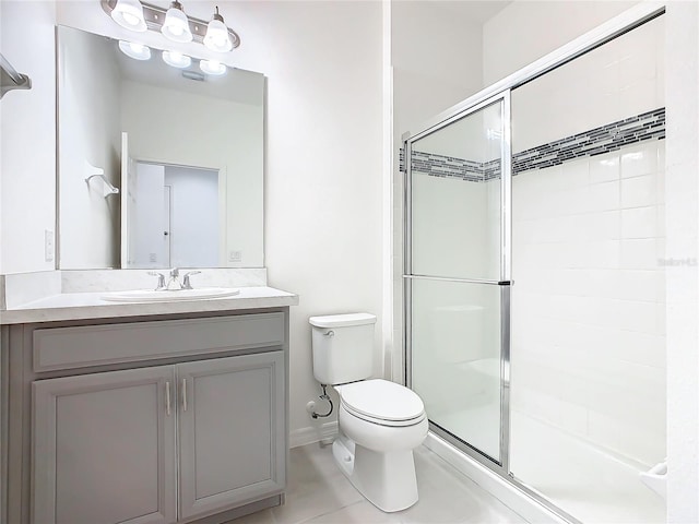 bathroom with vanity, toilet, and a shower with door