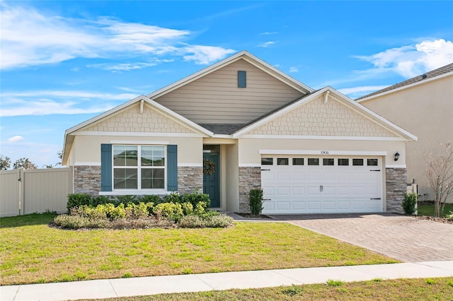 craftsman inspired home with a garage and a front yard