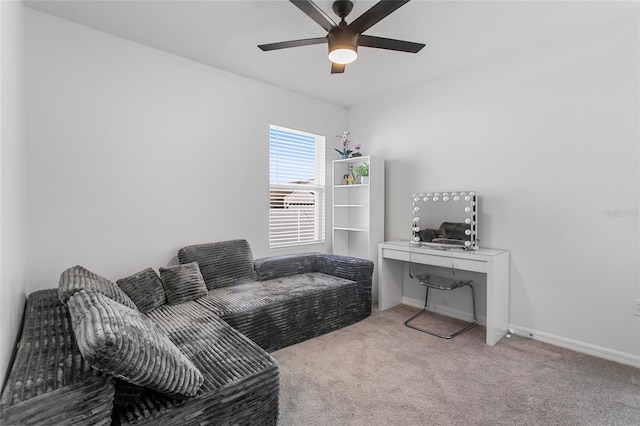 sitting room with ceiling fan and light colored carpet