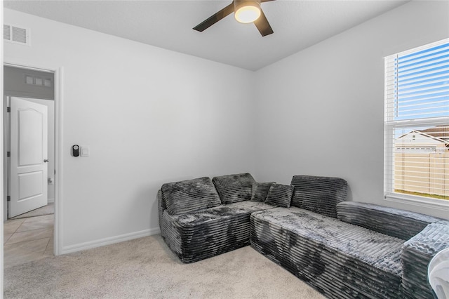 living room featuring light colored carpet and ceiling fan