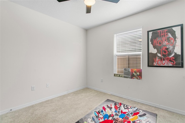 game room with a textured ceiling, ceiling fan, and carpet flooring