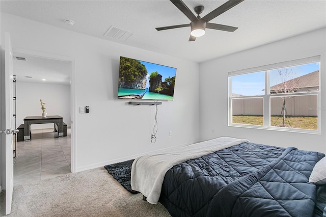 carpeted bedroom with a textured ceiling and ceiling fan