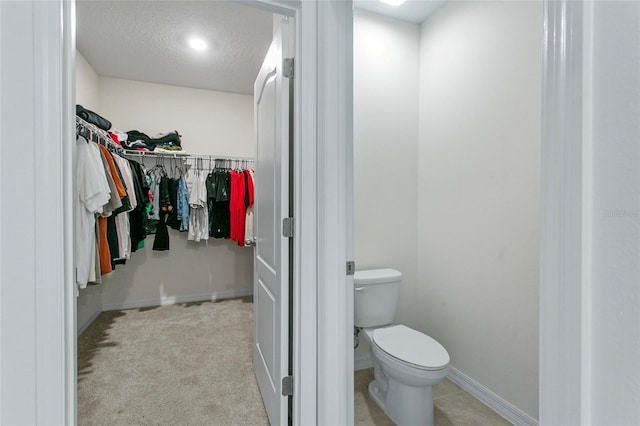 bathroom featuring a textured ceiling and toilet