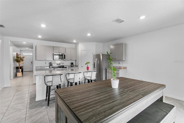 dining room with light tile patterned floors and a textured ceiling