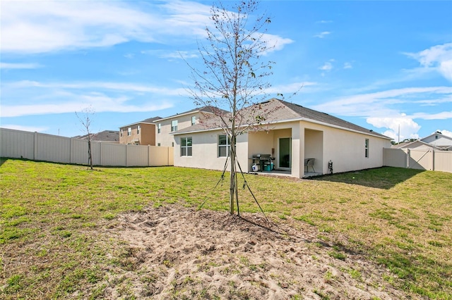 back of property featuring a yard