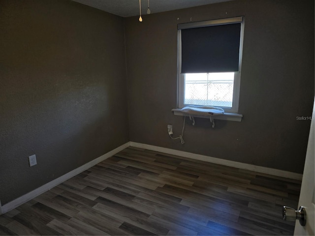 spare room with dark hardwood / wood-style flooring