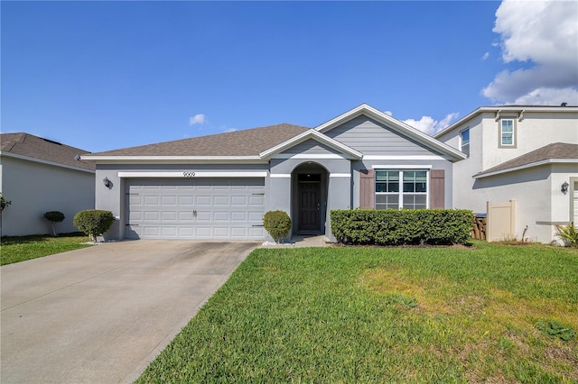 ranch-style home with a garage, driveway, roof with shingles, stucco siding, and a front lawn