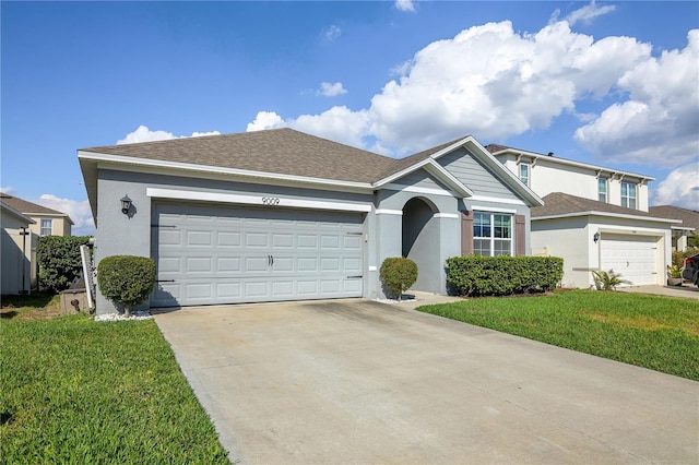 ranch-style home with roof with shingles, driveway, a front lawn, and stucco siding