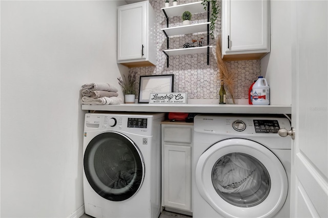 washroom with cabinet space and separate washer and dryer