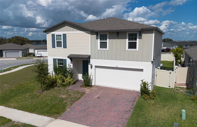 view of front of property featuring a front yard and a garage