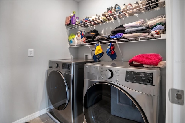 washroom with tile patterned flooring and separate washer and dryer