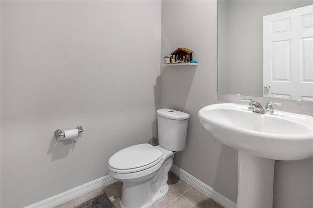 bathroom with toilet and tile patterned floors