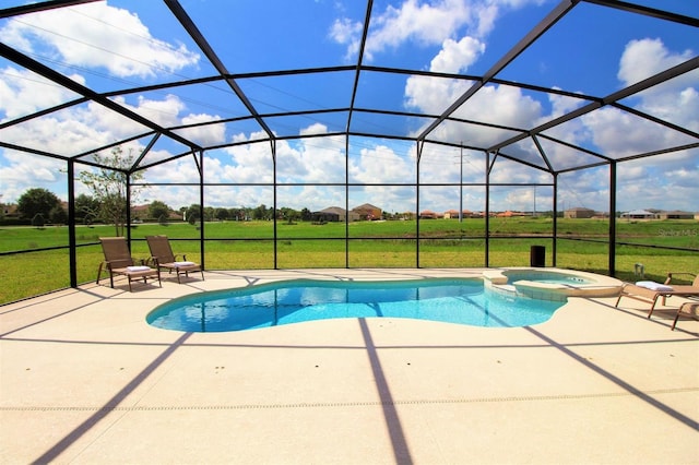 view of pool with a patio, a yard, a pool with connected hot tub, and glass enclosure