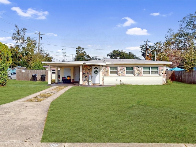 single story home featuring a front lawn and a carport