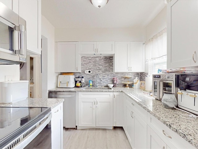 kitchen featuring sink and white cabinets