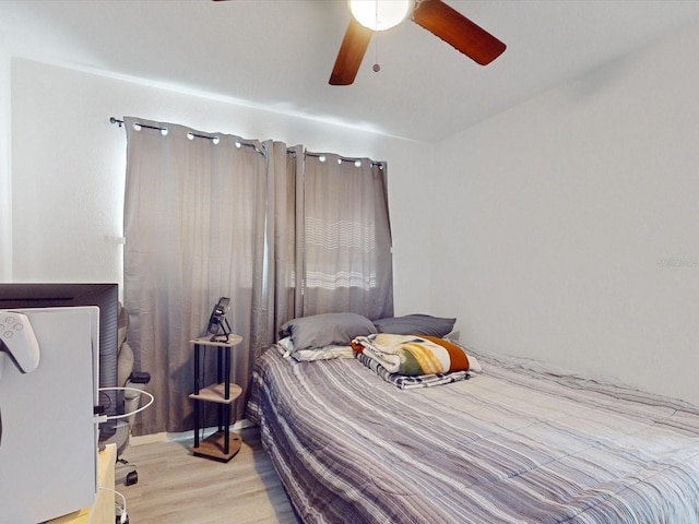 bedroom with ceiling fan and light hardwood / wood-style floors