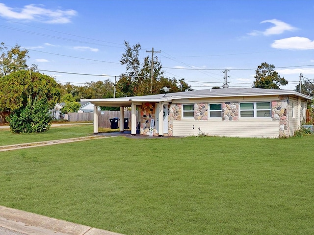 ranch-style home with a carport and a front lawn