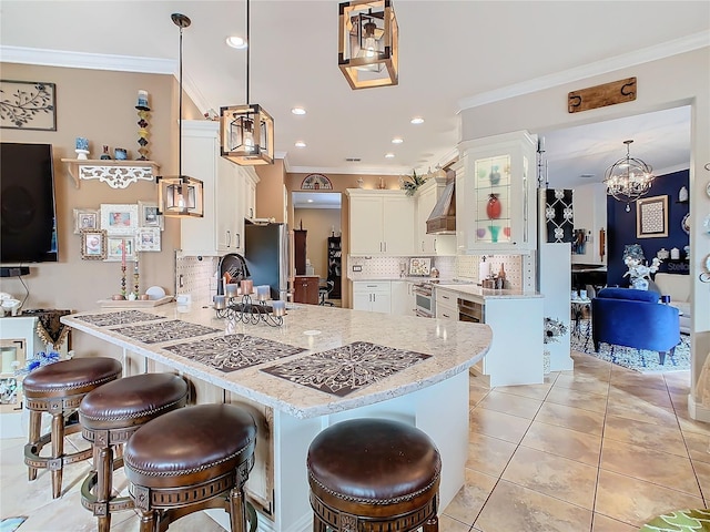 kitchen featuring decorative light fixtures, stainless steel fridge, white cabinets, custom exhaust hood, and crown molding