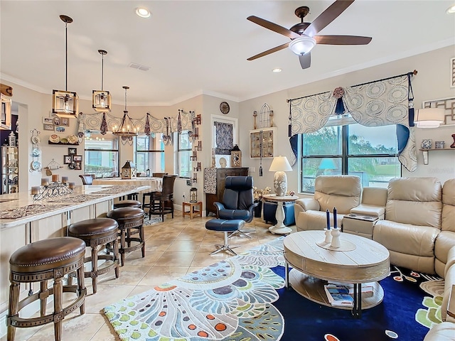 living room featuring light tile patterned flooring, ornamental molding, and ceiling fan with notable chandelier