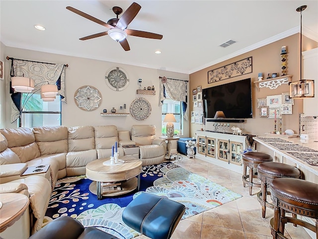 tiled living room with crown molding and ceiling fan