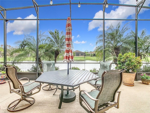 sunroom / solarium featuring a water view