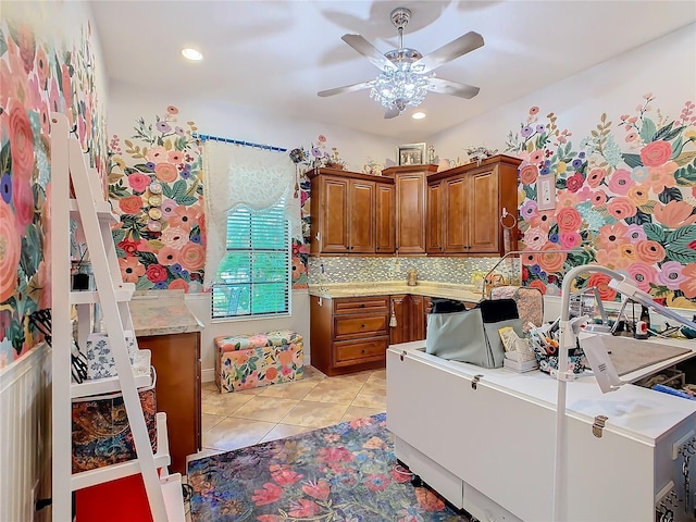 kitchen featuring tasteful backsplash, light tile patterned flooring, and ceiling fan