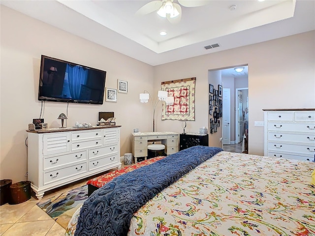 tiled bedroom featuring ceiling fan and a raised ceiling