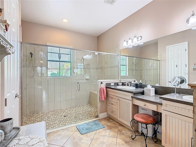 bathroom with vanity, tile patterned floors, a shower with door, and a healthy amount of sunlight