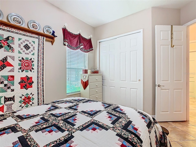 tiled bedroom featuring a closet