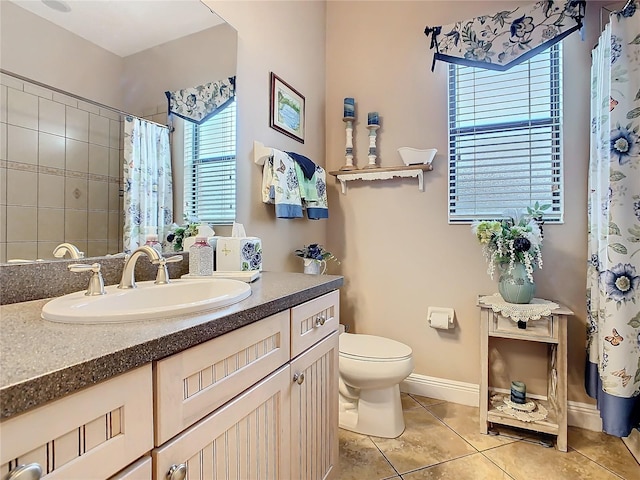 bathroom with vanity, curtained shower, tile patterned floors, and toilet