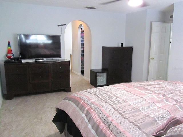 10409 Laxton St, Orlando, FL 32824 - tiled bedroom with arched walkways and a ceiling fan