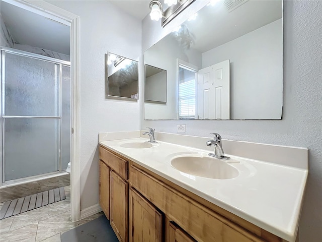 10409 Laxton St, Orlando, FL 32824 - bathroom with a stall shower, double vanity, marble look tiles, toilet, and a textured wall