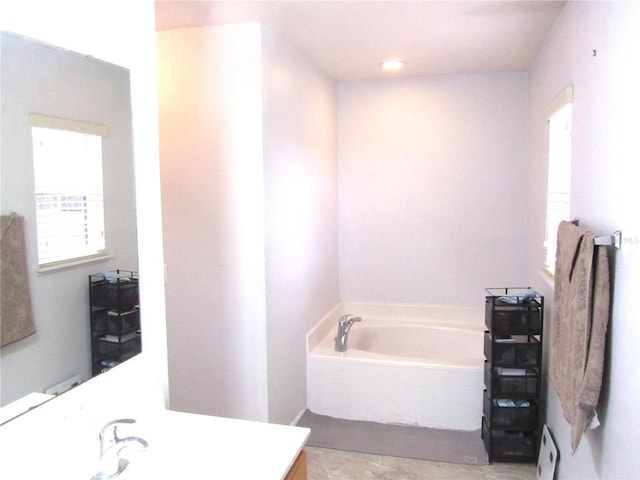 10409 Laxton St, Orlando, FL 32824 - bathroom with vanity and a garden tub