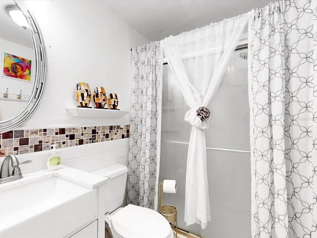 bathroom with vanity, toilet, a shower with shower curtain, and tile walls