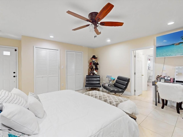 tiled bedroom with two closets and ceiling fan