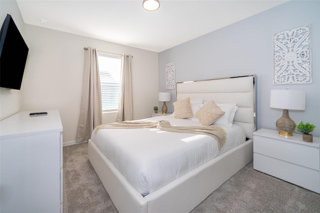 bedroom featuring light carpet