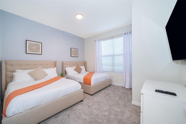 bedroom featuring light carpet