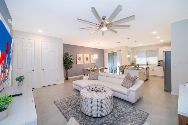 tiled living room featuring ceiling fan