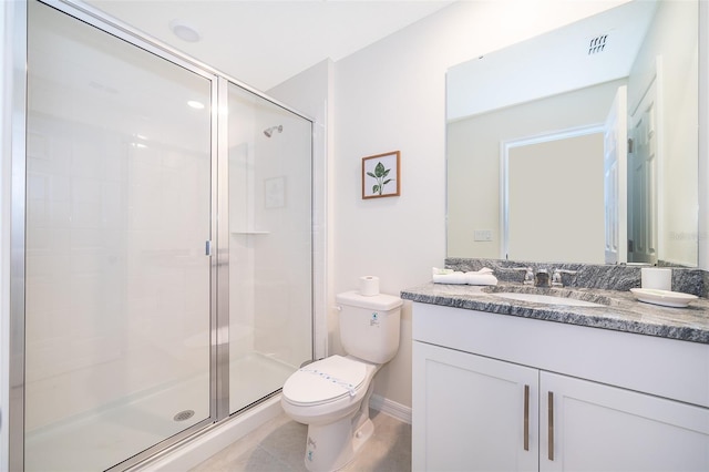 bathroom with vanity, a shower with shower door, tile patterned floors, and toilet