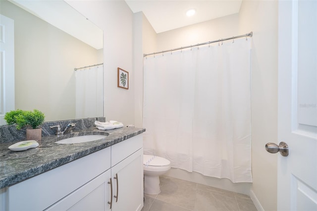 bathroom with vanity, toilet, and tile patterned flooring