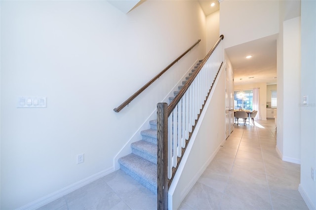 stairs featuring tile patterned flooring