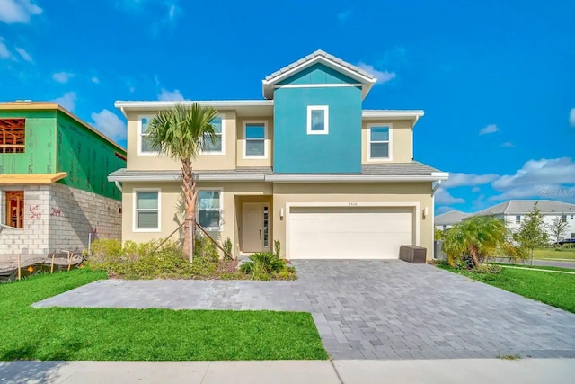 view of front facade with a front yard and a garage