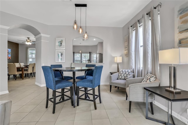 tiled dining space featuring ceiling fan