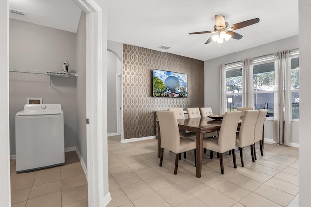 tiled dining area featuring washer / clothes dryer and ceiling fan