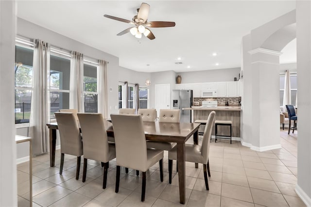 tiled dining area featuring ceiling fan