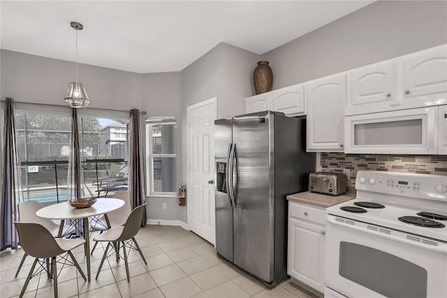 kitchen featuring light tile patterned flooring, decorative light fixtures, white appliances, decorative backsplash, and white cabinets