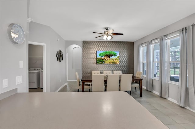 tiled dining space with vaulted ceiling and ceiling fan