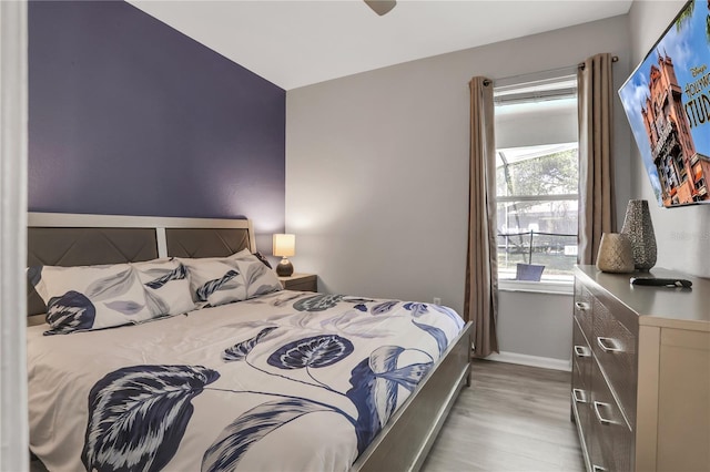 bedroom with ceiling fan and light wood-type flooring